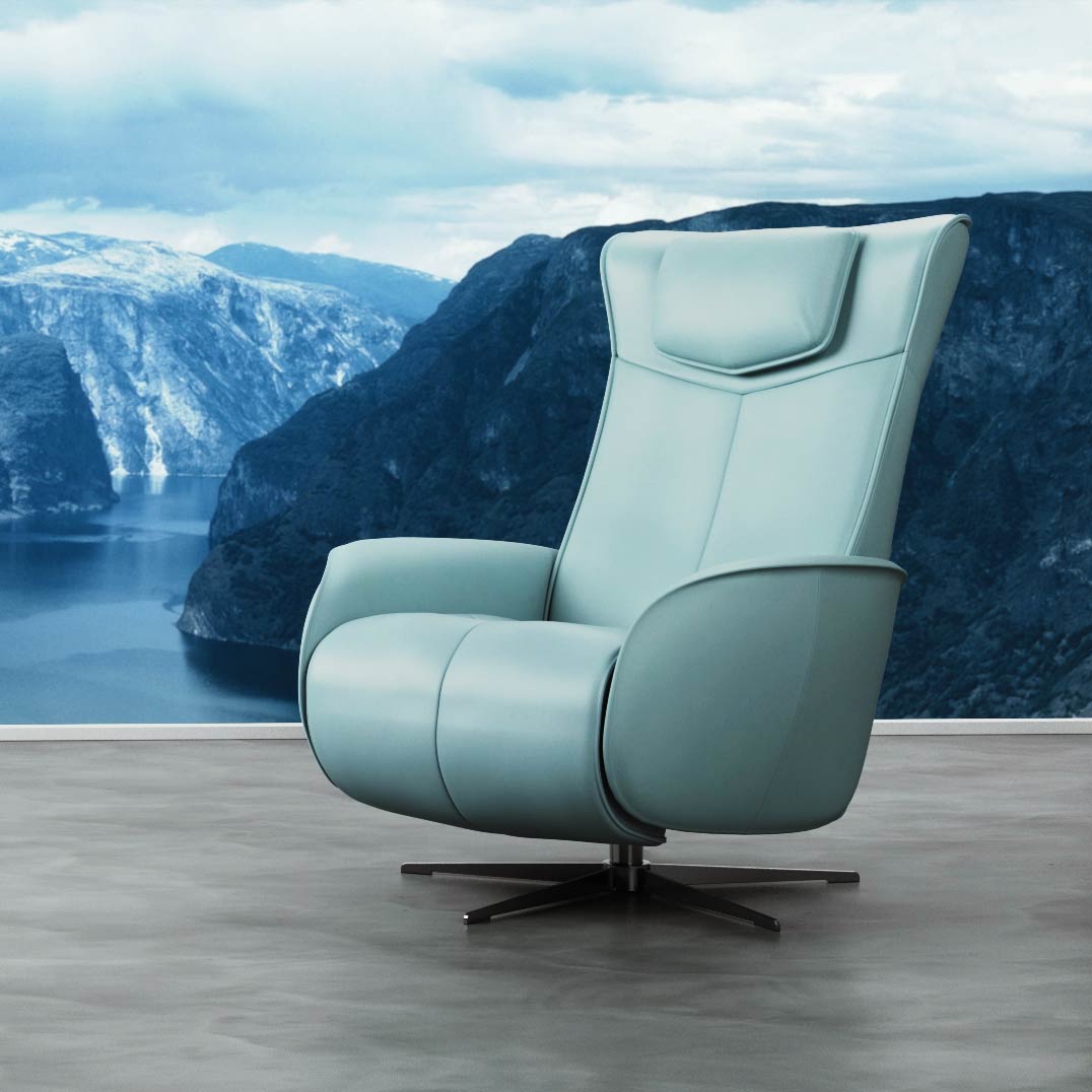 Teal comfortable office chair against a mountain background