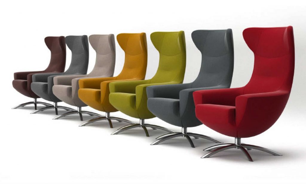 3D rendering of seven different colored armchairs against white background