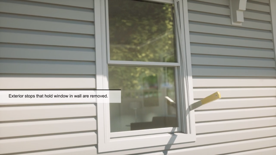 Exterior window on the side of a home with the text "Exterior stops that hold windows in wall are removed" from window installation training material