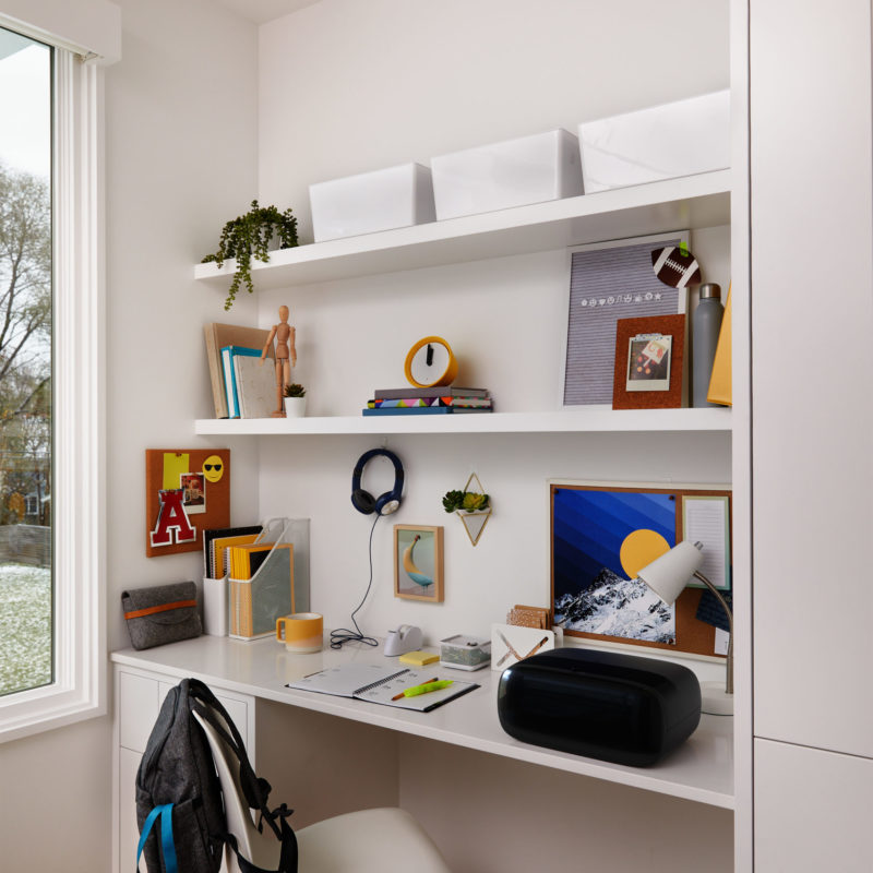 dorm room desk with white shelves